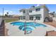 This backyard boasts a pool and integrated hot tub for relaxing and entertaining at 3604 N Campbell Rd, Las Vegas, NV 89129