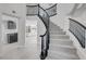 Elegant curving staircase with black railings and carpeted steps, leading to the upper level of the home at 3604 N Campbell Rd, Las Vegas, NV 89129