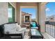 Cozy balcony with black wicker furniture and views of the neighborhood at 3729 Canis Minor Ln # 10206, Henderson, NV 89052