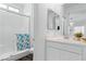 Bathroom features a glass-enclosed shower, white cabinetry, and contemporary fixtures at 3729 Canis Minor Ln # 10206, Henderson, NV 89052
