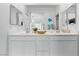 Bathroom featuring double sinks with white cabinetry, complemented by ample mirror space and modern fixtures at 3729 Canis Minor Ln # 10206, Henderson, NV 89052