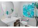 Stylish half bath with a modern sink, decor and a colorful piece of abstract art at 3729 Canis Minor Ln # 10206, Henderson, NV 89052
