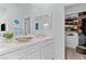 Bright bathroom with dual sinks, a spacious vanity, and a view into the well-organized walk-in closet at 3729 Canis Minor Ln # 10206, Henderson, NV 89052