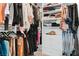 Walk-in closet with custom shelving, hanging racks, and organized storage solutions for clothes and accessories at 3729 Canis Minor Ln # 10206, Henderson, NV 89052