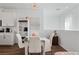 Chic dining area next to kitchen with modern chandelier, white table set, and wine storage at 3729 Canis Minor Ln # 10206, Henderson, NV 89052