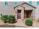 Charming townhouse entrance with a stone-accented porch and a well-maintained garden at 3729 Canis Minor Ln # 10206, Henderson, NV 89052