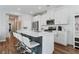 Stylish kitchen with white cabinets, stainless appliances, quartz countertop island, and wood-look floors at 3729 Canis Minor Ln # 10206, Henderson, NV 89052