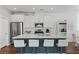 Modern kitchen with white cabinets, stainless steel appliances, and a large center island with seating at 3729 Canis Minor Ln # 10206, Henderson, NV 89052