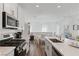 Modern kitchen featuring stainless appliances, quartz counters, and seamless flow to the dining area at 3729 Canis Minor Ln # 10206, Henderson, NV 89052