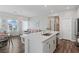 Open kitchen showcasing a quartz countertop island and stainless sink open to a living space at 3729 Canis Minor Ln # 10206, Henderson, NV 89052