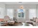 Inviting living room featuring sheer curtains, modern lighting, and comfortable seating arrangement at 3729 Canis Minor Ln # 10206, Henderson, NV 89052