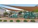 Community playground with slides, swings, and shade covers for Gathering fun at 3729 Canis Minor Ln # 10206, Henderson, NV 89052