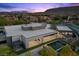An aerial view showcases the contemporary home's layout, set against a backdrop of the Las Vegas mountains at 38 Skybird Ct, Las Vegas, NV 89135