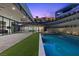Stunning backyard with pool, lush landscaping, and a modern home design at twilight at 38 Skybird Ct, Las Vegas, NV 89135