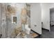 Elegant bathroom featuring marble tile walls, modern fixtures, and a glass-enclosed shower stall at 38 Skybird Ct, Las Vegas, NV 89135