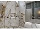 Stunning marble shower with dual showerheads, built-in niche, and glass door at 38 Skybird Ct, Las Vegas, NV 89135