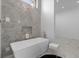 Elegant bathroom features a freestanding tub and marble accent wall at 38 Skybird Ct, Las Vegas, NV 89135