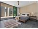 Bright bedroom with wood-accented walls, plush rug, and sliding glass doors opening to the courtyard at 38 Skybird Ct, Las Vegas, NV 89135