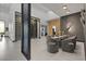 Open dining area with stylish gray chairs, modern lighting, and access to the wine room at 38 Skybird Ct, Las Vegas, NV 89135