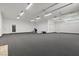 Large garage with overhead lighting, white walls, and a gray carpet at 38 Skybird Ct, Las Vegas, NV 89135