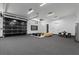 Spacious garage with black glass door, seating area, and ample room for multiple vehicles at 38 Skybird Ct, Las Vegas, NV 89135