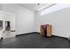 Spacious exercise room with large windows, sleek dark flooring, and modern decor at 38 Skybird Ct, Las Vegas, NV 89135