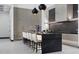 Bright kitchen with sleek cabinets, a black island, and modern pendant lighting at 38 Skybird Ct, Las Vegas, NV 89135