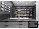 Stylish kitchen with sleek gray cabinetry, modern appliances, and contemporary decor at 38 Skybird Ct, Las Vegas, NV 89135