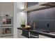 Gourmet kitchen with stainless steel appliances, a black countertop, and tile backsplash at 38 Skybird Ct, Las Vegas, NV 89135
