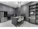 Modern kitchenette featuring sleek cabinetry, stainless steel appliances, and bar seating at 38 Skybird Ct, Las Vegas, NV 89135