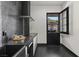 Modern kitchenette featuring black countertops and cabinetry with access to outdoor pergola seating at 38 Skybird Ct, Las Vegas, NV 89135