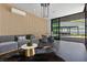 Contemporary living space with stylish decor, wood-accented walls, and glass doors to the outdoor lounge at 38 Skybird Ct, Las Vegas, NV 89135