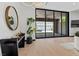 Bright living room featuring a sliding glass door, hardwood floors and sleek modern decor at 38 Skybird Ct, Las Vegas, NV 89135