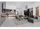 Spacious living room featuring tile flooring, modern furnishings, and an open layout connected to the kitchen at 38 Skybird Ct, Las Vegas, NV 89135