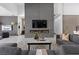 Modern living room with a fireplace, gray sofas, and a contemporary design at 38 Skybird Ct, Las Vegas, NV 89135