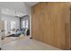 Modern living room featuring wood paneling, light wood floors, and a comfortable gray couch at 38 Skybird Ct, Las Vegas, NV 89135