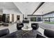 Open-concept living space with modern furnishings, a wine room, and seamless indoor-outdoor transition to a patio at 38 Skybird Ct, Las Vegas, NV 89135
