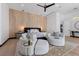 Spacious main bedroom with a decorative wood panel wall, ceiling fan, and sitting area at 38 Skybird Ct, Las Vegas, NV 89135