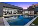 Modern home featuring a backyard pool with an adjacent covered outdoor space, perfect for entertaining at 38 Skybird Ct, Las Vegas, NV 89135