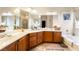 The main bathroom features double sinks, granite countertops, a large mirror, and a soaking tub at 4015 Galiceno Dr, Las Vegas, NV 89122