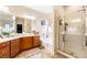 The main bathroom features double sinks, granite countertops, a soaking tub, and a glass door shower at 4015 Galiceno Dr, Las Vegas, NV 89122