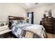 Comfortable bedroom with a queen bed, a window, a nightstand, a dresser, and a small chair at 4015 Galiceno Dr, Las Vegas, NV 89122