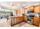 Well-lit kitchen features stainless steel appliances, wooden cabinets, and an adjacent eat-in area at 4015 Galiceno Dr, Las Vegas, NV 89122