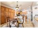 This eat-in kitchen features wooden cabinets, granite countertops, and a view of the living room at 4015 Galiceno Dr, Las Vegas, NV 89122