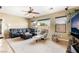 Comfortable living room with a ceiling fan, plush seating, and large windows for natural light at 4015 Galiceno Dr, Las Vegas, NV 89122
