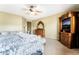 The main bedroom features a ceiling fan, a king size bed, a sitting area with a couch, and a large dresser at 4015 Galiceno Dr, Las Vegas, NV 89122