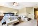 The main bedroom features a ceiling fan, a king size bed, and a sitting area with a couch at 4015 Galiceno Dr, Las Vegas, NV 89122
