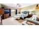 The main bedroom features a ceiling fan, a king size bed, and a sitting area with a couch at 4015 Galiceno Dr, Las Vegas, NV 89122