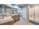 Well-appointed bathroom with double vanity, granite countertops, and glass-enclosed shower at 4439 Bayley Skye Ave # 105, Las Vegas, NV 89141