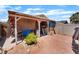 Backyard with a covered patio, seating area, and a small garden bed at 4565 Halbert Ave, Las Vegas, NV 89110